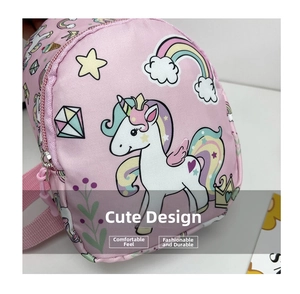 Close-up of pink unicorn chest bag for kids with rainbow patterns and smooth zipper detail