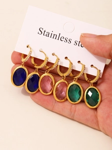 Detail view of 3 pairs of oval Czech glass earrings in navy blue, pink, and emerald green