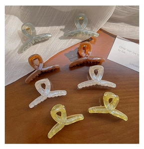 Flat lay of colorful 4.5cm translucent jelly hair claws in various twisted designs