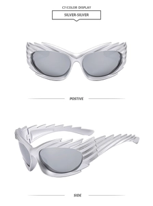 Detail of silver wing-shaped Y2K sunglasses with grey lenses and metallic finish
