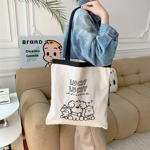 Detail of canvas tote bag with lucky letter print and cute cartoon bear patterns