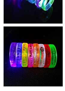 Macro shot of colorful LED bubble bracelets glowing in dark with vibrant neon light effects
