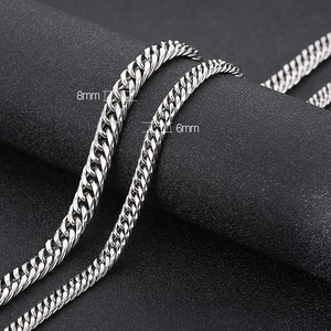 Polished silver cuban curb chains in 6mm and 8mm widths on black display stand