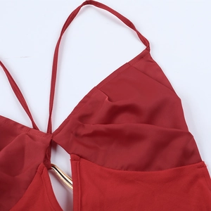 Close-up of sexy red halter dress neckline featuring a decorative gold metal ring connector