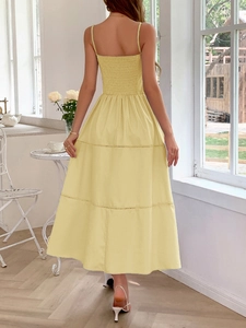 Back view of a yellow tiered midi dress with ruched detailing and thin straps