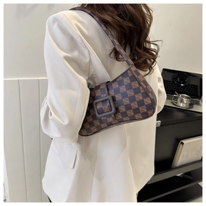Close-up showing the vintage dark brown checkered shoulder bag on a model side-profile