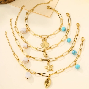 Gold chain bracelets with shell and starfish charms on a natural wood background