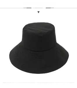 Front view of black wide-brim bucket hat showing breathable mesh texture and sun protection