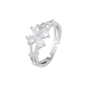 Macro shot of adjustable silver ring featuring pear-cut zircon clover and vine details