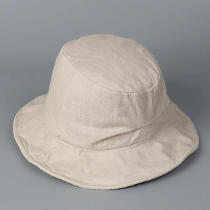 Detail view showing the clear linen fabric texture of this beige sun protection bucket hat