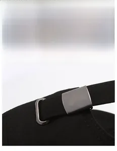 Detail of adjustable matte silver metal buckle on black herringbone fabric baseball cap