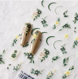 Macro detail of embossed nail art stickers with green leaves and yellow floral patterns