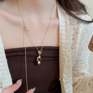 Vue détaillée du collier d'étoile en perles et oeil de tigre porté par un mannequin femme