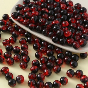 Macro view of 10mm cracked glass beads with red and black glaze for jewelry making