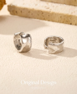 Detail of S925 sterling silver C-shaped hoop earrings with sparkling crystal pavé stones