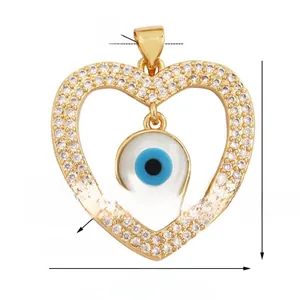 Detailed view of heart evil eye pendant with natural shell and white zircon stones