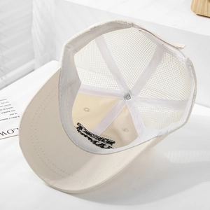 Detailed interior of beige mesh baseball cap showing breathable structure and stitching