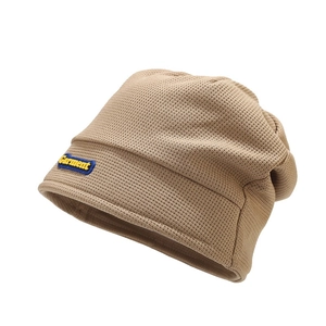 Women's beige waffle knit beanie with Garment label for winter warmth and comfort