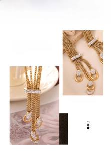 Detail of multi-layer gold chain necklace with diamond-encrusted pendant and tassel