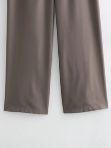 Detail of dark gray wide-leg trousers hem showing smooth suit fabric texture