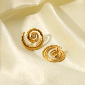 Golden spiral conch earrings with zircon accent on elegant beige silk background