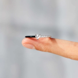 Heart-shaped gemstone ring with a unique black enamel and diamond-paved split band design