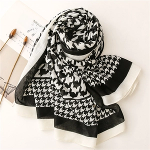 Close-up of classic black and white houndstooth scarf with soft cotton-linen texture