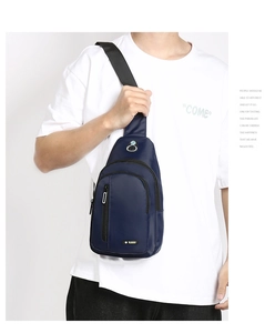 Detail of blue waterproof oxford fabric chest bag with earphone port and zip pocket