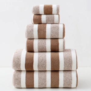 Detail showing 6-piece brown and white striped towel set stacked in a pyramid shape