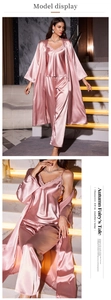 Close-up of pink satin three-piece sleepwear set with lace V-neck and silk texture