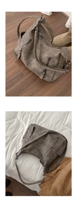 Close-up of vintage taupe hobo tote bag featuring dual front metal zipper pockets