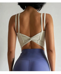 Close-up of cream white sports bra featuring stylish twist-back design and thin dual straps