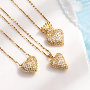 Three gold heart pendant necklaces with crown detail and pavé cubic zirconia inlay