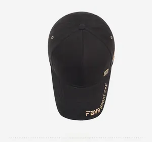 Top view of black baseball cap with gold embroidered lettering on brim detail