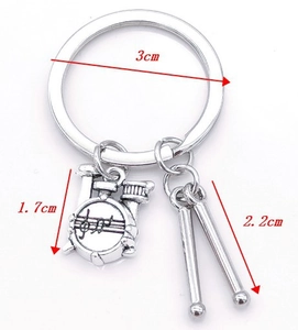 Detail showing music keychain dimensions with drums pendant and sticks in polished silver alloy