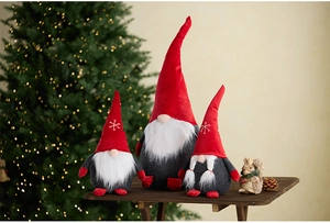 Three Christmas gnomes with telescopic legs and embroidered snowflake hats on wood