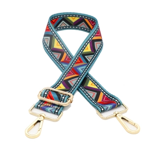 Detail of adjustable ethnic style woven bag strap with golden metal swivel hooks