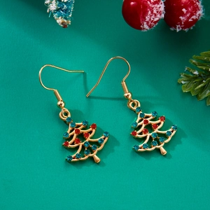 Macro shot of gold Christmas tree earrings with sparkling red and green rhinestones
