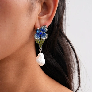 Detailed macro shot of baroque pearl earring with vibrant multi-colored rhinestones