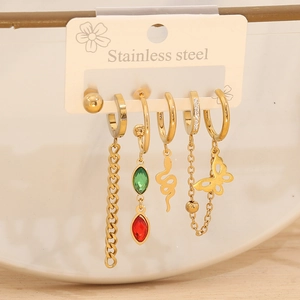 Detail of gold stainless steel earrings featuring snake, butterfly and stone charms