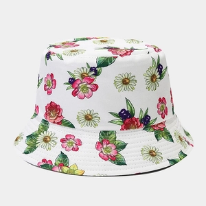 Detailed view of the colorful floral print on a white cotton bucket sun hat