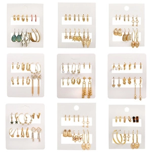 Detailed grid view of diverse gold boho earrings featuring tassels and pearls