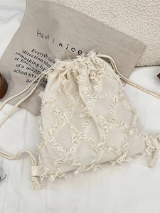 Beige canvas drawstring backpack with geometric fringe pattern and textured cotton cord