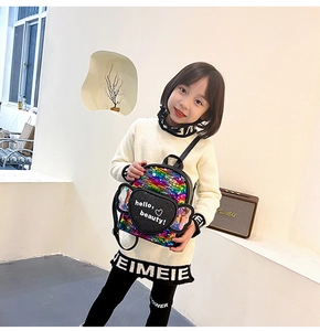 Kids sequin backpack detail featuring colorful sequins and cute black heart pocket