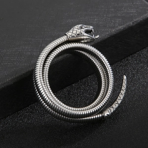 Detailed view of silver snake-shaped coiled bracelet showing intricate scale textures
