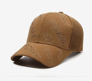Detail of rhinestone FDMY letters on a brown mesh baseball cap for women