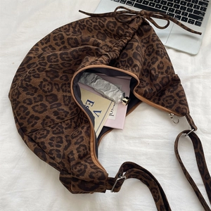 Macro shot of large capacity leopard print tote bag with zipper and drawstring detail
