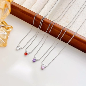 Minimalist silver deer antler necklaces with colorful gemstone pendants in a gift box