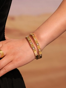 Detail of 18k gold plated stainless steel bangles set with sparkling zircon stones