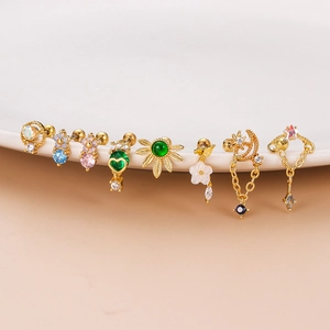 Set of eight gold stainless steel flower and zircon stud earrings on ceramic tray